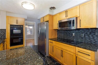 Kitchen view towards dining room showing cooktop, 