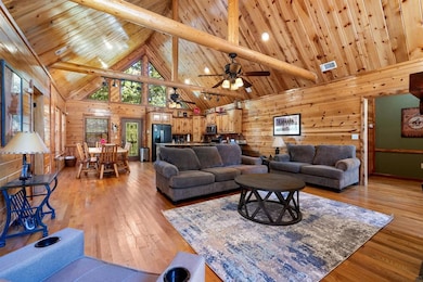 Living room with high vaulted ceiling, light wood-
