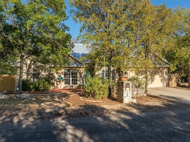 Obstructed view of property with driveway, a gara