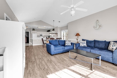 Living area featuring lofted ceiling, light wood-t