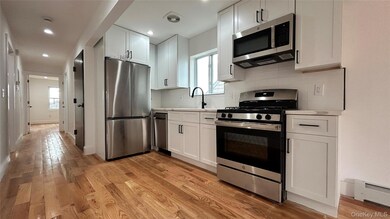 Kitchen featuring appliances with stainless steel finishes, light countertops, light wood finished floors, white cabinetry, and recessed lighting