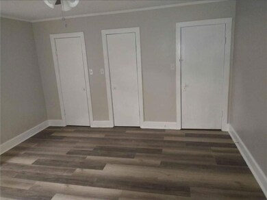 Unfurnished bedroom with dark hardwood / wood-styl