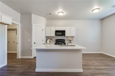 Laundry room access from the kitchen leads to the 