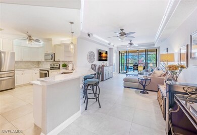 Kitchen featuring ceiling fan, appliances with stainless steel finishes, hanging light fixtures, and backsplash