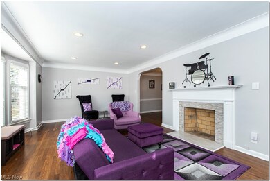 Living room: note the recessed lighting and wide bay front windows