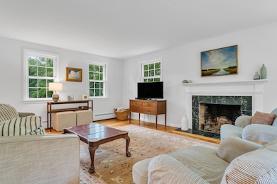 Hardwood floors and a fireplace accent the living room