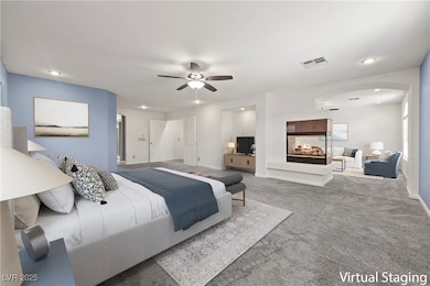 Bedroom with arched walkways, carpet, a multi side