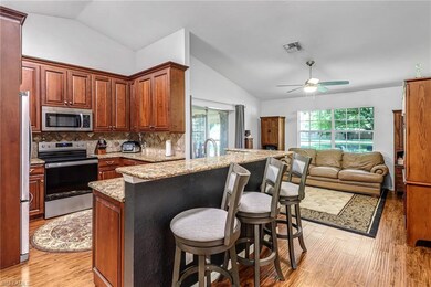 Kitchen featuring a breakfast bar area, vaulted ce