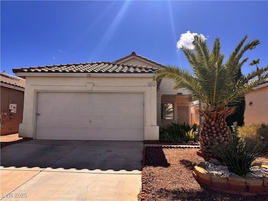 View of front of property with driveway, stucco siding, a tile roof, and a garage