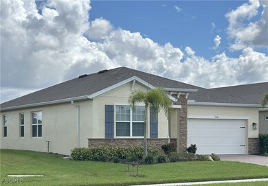 View of front of home with stone siding, stucco siding, and a front yard