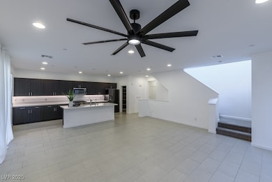 Kitchen with stainless steel microwave, light coun
