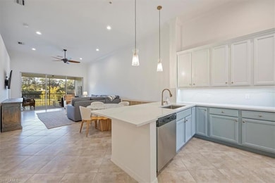 Kitchen featuring ornamental molding, a peninsula, hanging light fixtures, dishwasher, and light tile patterned floors