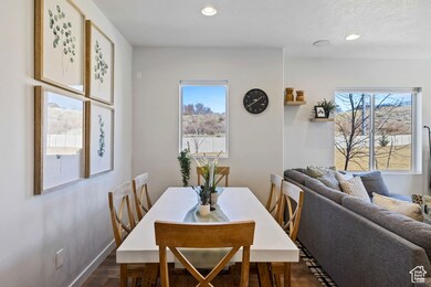 Dining space featuring plenty of natural light, recessed lighting, and dark wood-type flooring