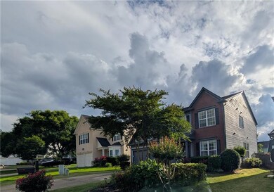 Traditional-style house with a front yard and brick siding