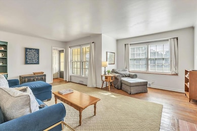 Living area with wood finished floors and baseboards