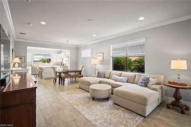 Living room with crown molding and recessed lighting
