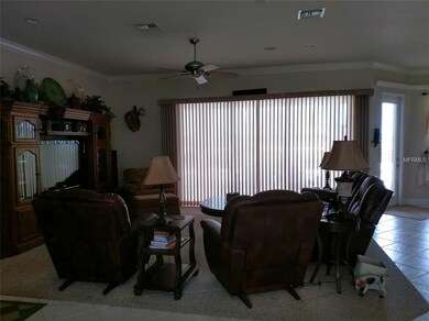 Large living room has recessed lighting and triple