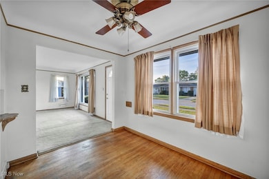 Unfurnished room featuring plenty of natural light, wood finished floors, and a ceiling fan