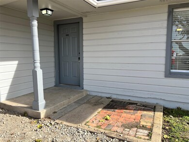 This is the front entrance, with a covered porch and an overhead light for convenience. Notice the brick pathway.