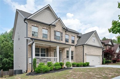 Craftsman-style home with fence, brick siding, a s