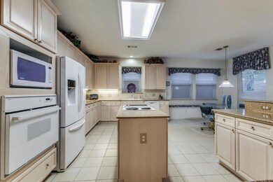 Massive Kitchen has island w-cooktop, white applia