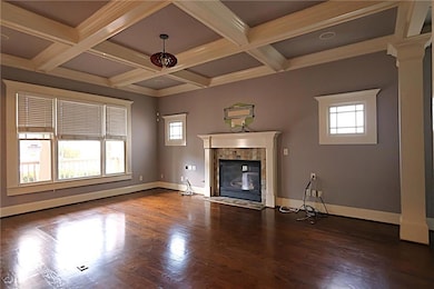 Living room with fireplace and coffer ceilings