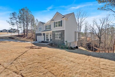 View of front of home with an attached garage, sto