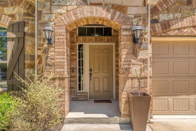 Entrance to property featuring stone siding and a