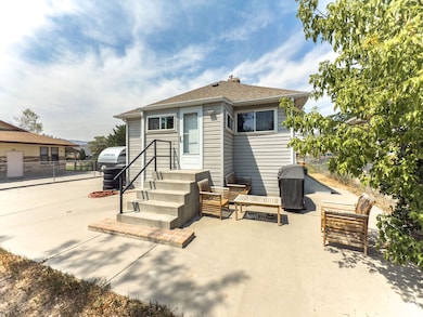 Rear view of property with a patio area and a shingled roof