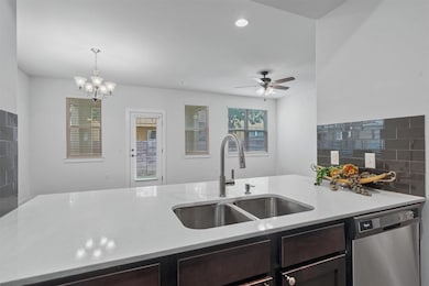Kitchen featuring stainless steel dishwasher, a sink, dark brown cabinets, ceiling fan, and recessed lighting