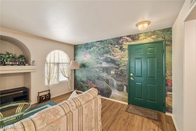 Foyer entrance featuring wallpapered walls, an acc