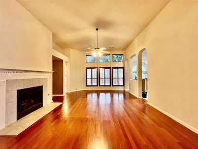 Unfurnished living room with ceiling fan, wood fi