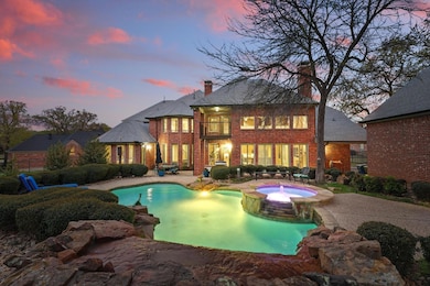 Pool at dusk with a pool with connected hot tub an