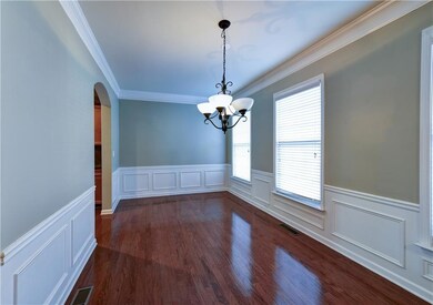 Unfurnished dining area with crown molding, visibl