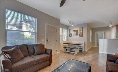 Living area with baseboards, light tile patterned