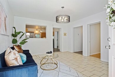 Sitting room with a chandelier and light tile patterned flooring