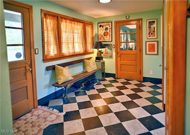 Entryway with light flooring and baseboards