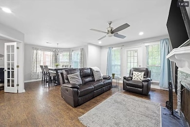 Living area with ceiling fan with notable chandeli