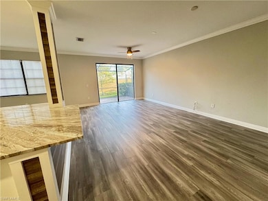 Unfurnished living room featuring a ceiling fan, o