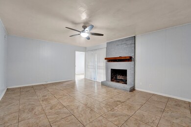 Unfurnished living room with ceiling fan, a firepl