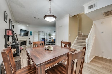 Dining area featuring a tile fireplace, a textured