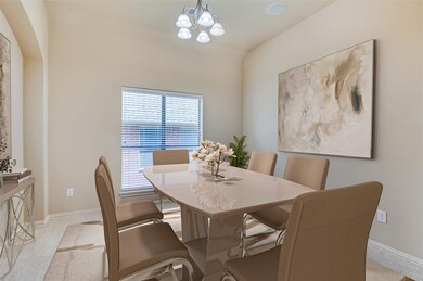 Dining area with a chandelier and natural light.Vi