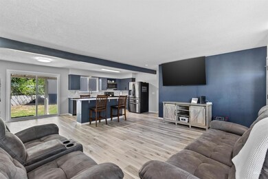 Living room featuring baseboards and light wood-type flooring