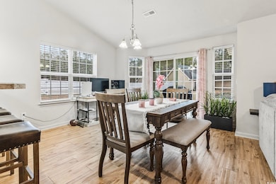 Dining space featuring lofted ceiling, a chandelie