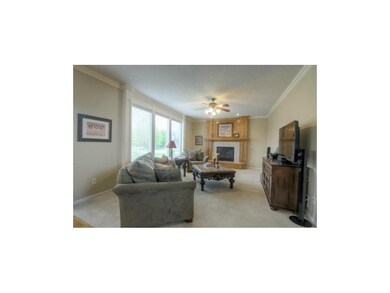 Living room w/fireplace & ceiling fan
