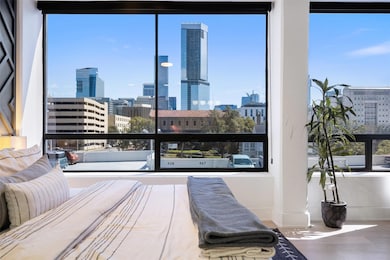 Bedroom with a skyline view, baseboards, and mult