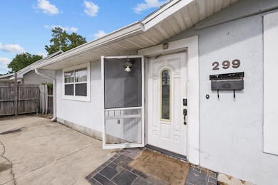 Doorway to property featuring stucco siding