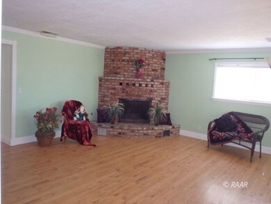 Entering home to living room w/fireplace