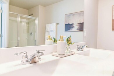 Full bathroom with a stall shower, double vanity, 
