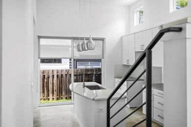 Staircase with concrete floors and a towering cei